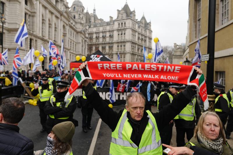 Masked man in Celtic tracksuit led away by police at Palestine protest